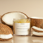 Load image into Gallery viewer, Peppermint bath salt jar with coconut pieces on beige background, relaxation product