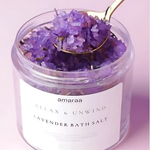 Load image into Gallery viewer, Lavender bath salt in clear jar with gold spoon, amaraa brand, on light pink background