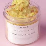 Load image into Gallery viewer, Jar of amaraa Relax + Unwind peppermint bath salt with yellow bath crystals on pink background