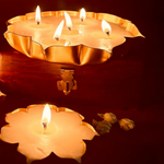 Load image into Gallery viewer, Flower-shaped decorative candles burning on a wooden box, warm ambient lighting