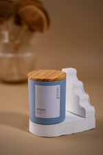 Load image into Gallery viewer, Blue Amaraa soy wax candle jar with wooden lid on white display, minimalist decor