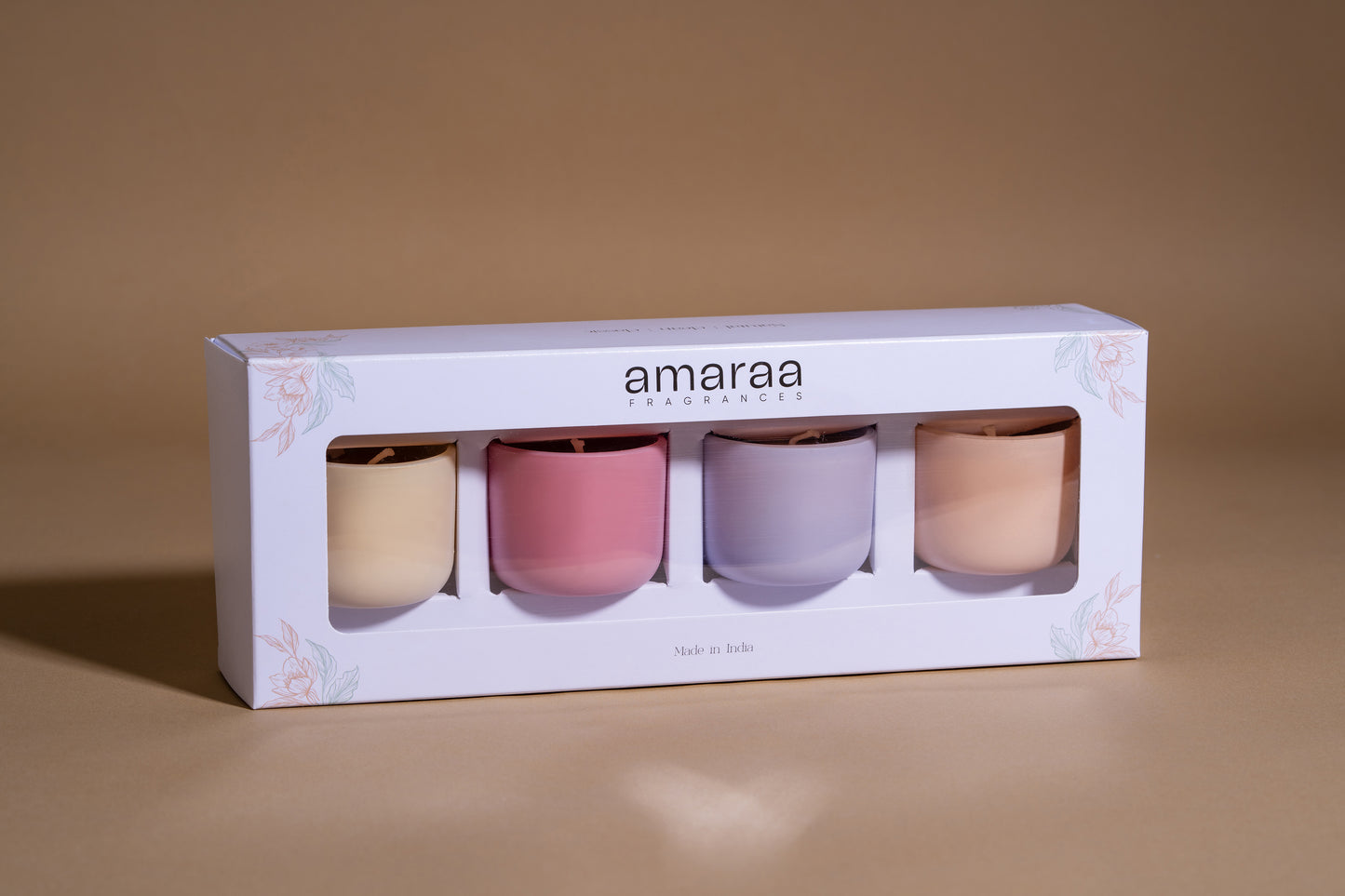 Amaraa Fragrances pastel colored candle gift set in floral white packaging on beige background