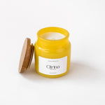 Load image into Gallery viewer, Yellow candle jar labeled Citrina with wooden lid on white background