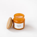 Load image into Gallery viewer, Amber glass Espresso Euphoria candle with wooden lid on white background