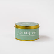 Lemongrass soy wax candle in green tin container with gold lid on white background