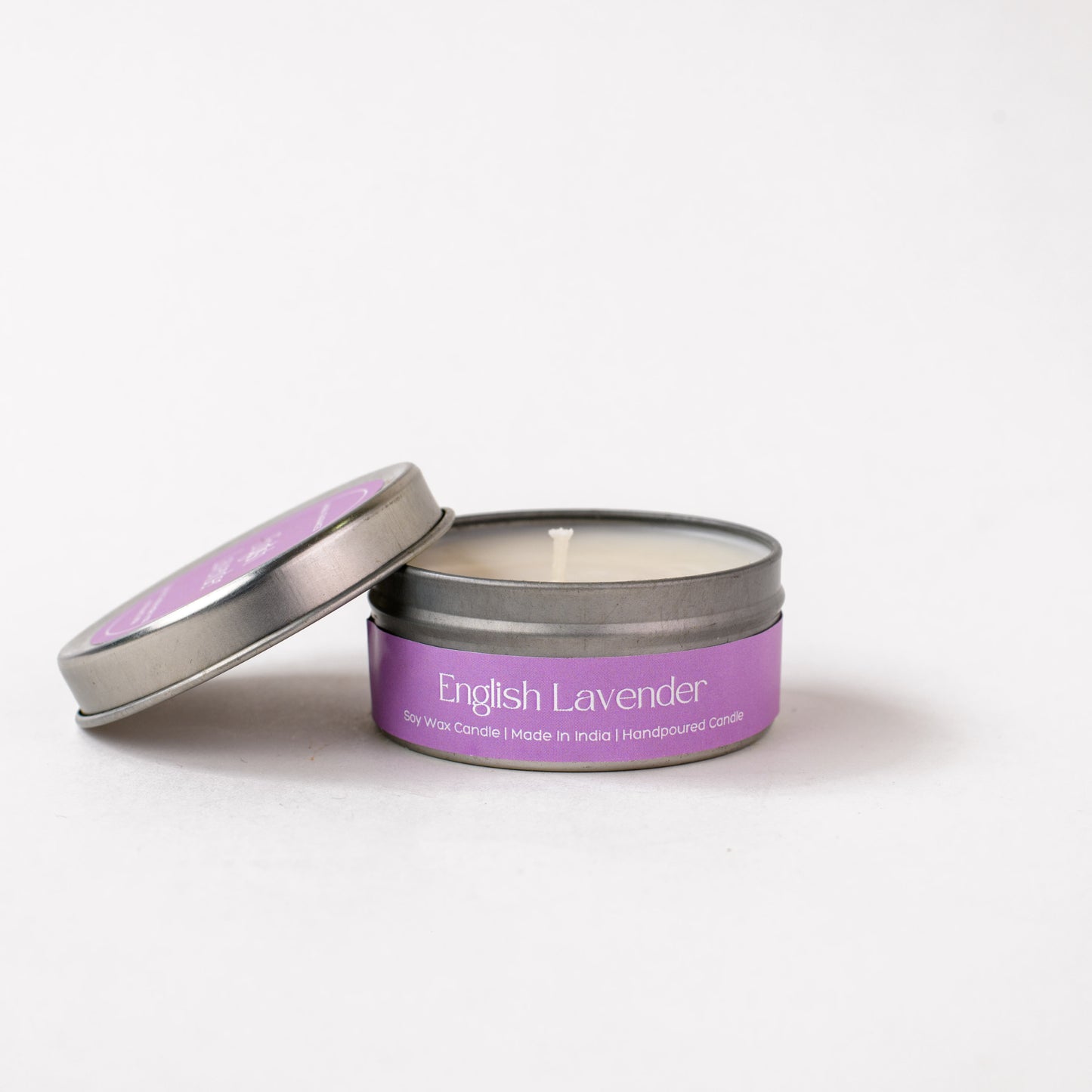English Lavender soy wax candle in a round metal tin with purple label on white background