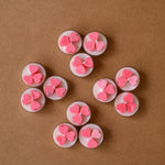 Load image into Gallery viewer, Pink heart-shaped tealight candles arranged on brown background