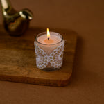 Load image into Gallery viewer, Decorative lace-wrapped candle in glass holder on wooden tray, warm brown background
