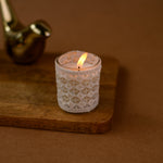 Load image into Gallery viewer, Decorative white lace candle in glass on wooden tray, brown background, cozy home decor