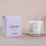 Load image into Gallery viewer, Classic soy wax candle in clear glass jar with pine scent, next to branded box