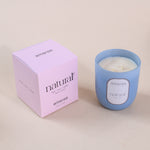 Load image into Gallery viewer, Amaraa natural soy wax candle in blue glass with pink box on beige surface