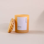 Load image into Gallery viewer, Yellow soy wax candle in glass jar with wooden lid on neutral background, amaraa eternal label