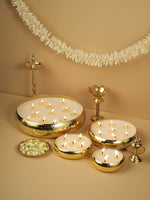 Load image into Gallery viewer, Brass urli with floating candles, jasmine flowers, and traditional brass lamps on beige background