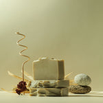 Load image into Gallery viewer, Handcrafted natural soap bars stacked with stones and dried flower on a neutral background