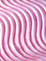 Load image into Gallery viewer, Close-up of textured pink buttercream frosting with wavy, even piping lines