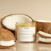 Peppermint bath salt jar with coconut pieces on beige background, relaxation product