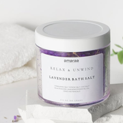 Amaraa lavender bath salt jar on white stone with towels and plant, relaxing spa product