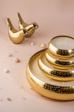 Load image into Gallery viewer, Gold hammered metal candles and gold bird figurines on a soft peach background