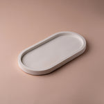 Load image into Gallery viewer, Minimalist white oval tray on a beige background, modern home decor accent piece