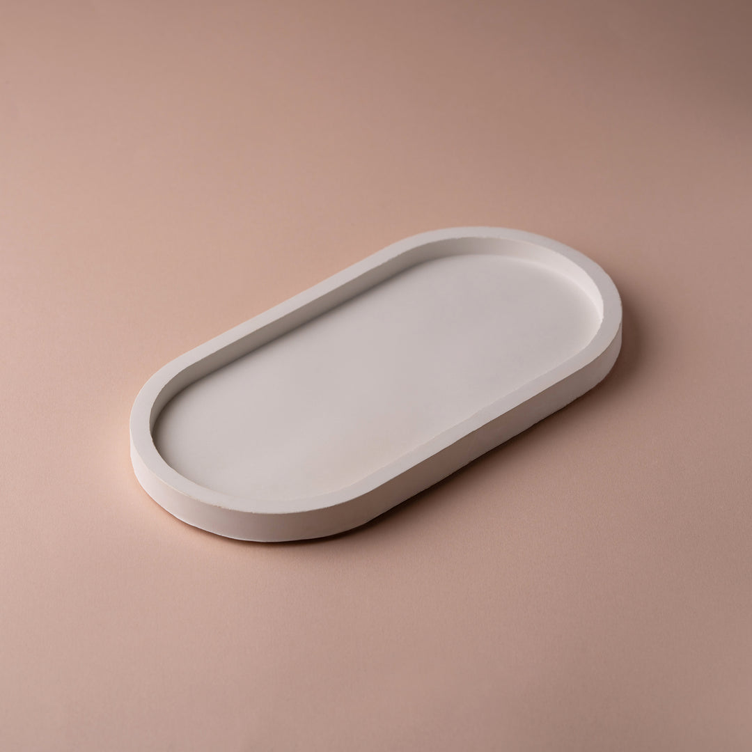 Minimalist white oval tray on a beige background, modern home decor accent piece