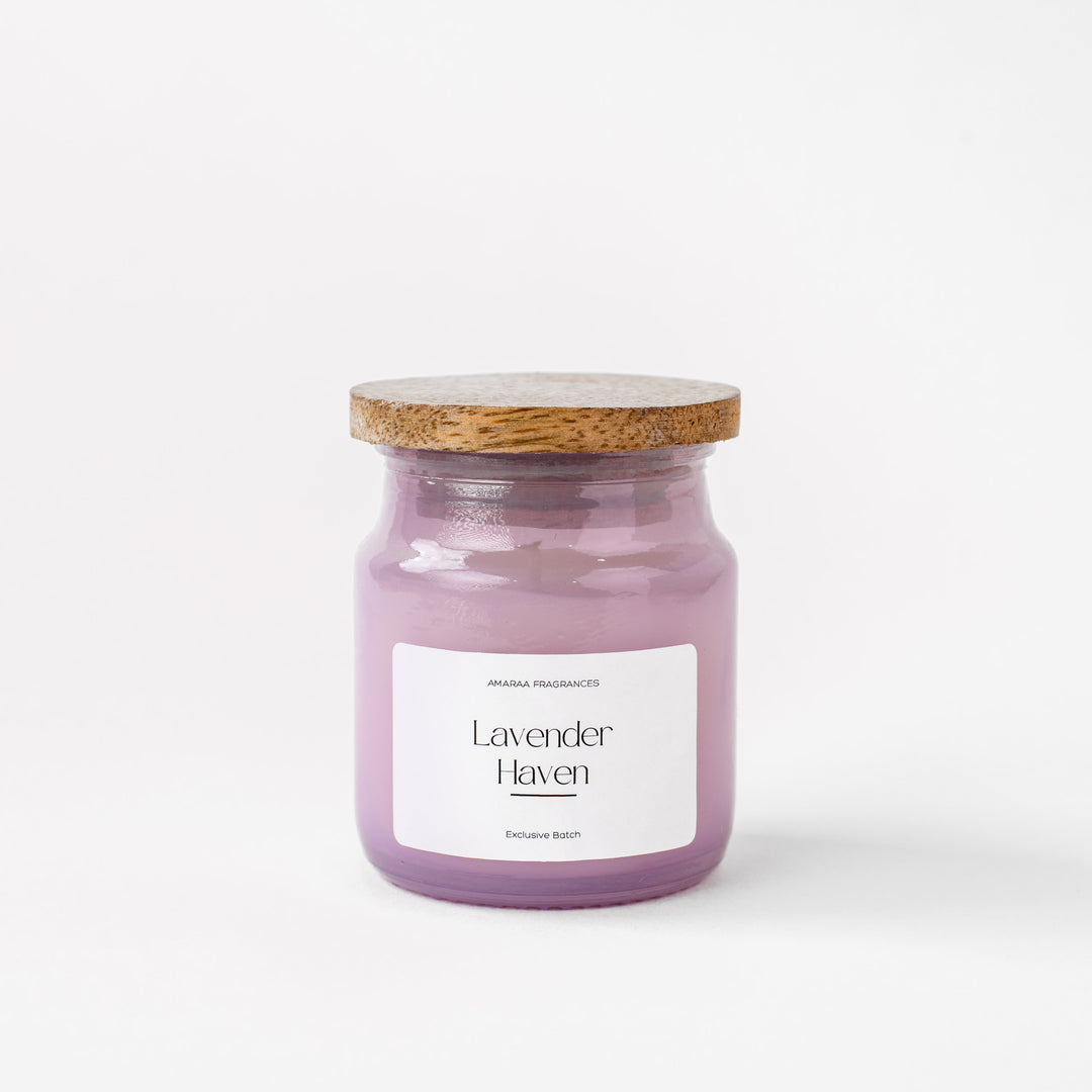 Lavender Haven scented candle in a purple glass jar with wooden lid on white background