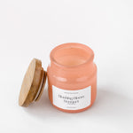 Load image into Gallery viewer, Blushing Bloom Bouquet scented candle in pink glass jar with wooden lid on white background