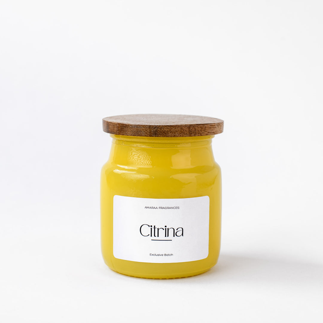 Yellow Citrina scented candle jar with wooden lid on white background