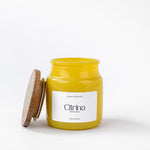 Load image into Gallery viewer, Yellow Citrina scented candle in glass jar with wooden lid on white background