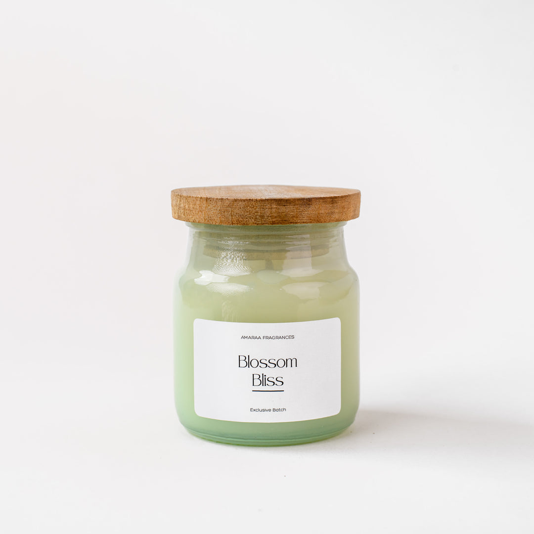 Blossom Bliss scented candle in glass jar with wooden lid on white background