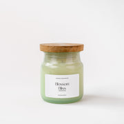 Blossom Bliss scented candle in glass jar with wooden lid on white background