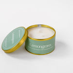 Load image into Gallery viewer, Lemongrass soy wax candle in gold tin with green label and partially opened lid on white background