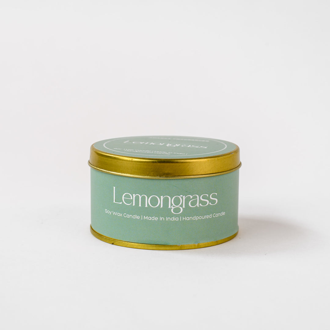 Lemongrass soy wax candle in green tin container with gold lid on white background