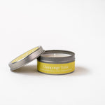Load image into Gallery viewer, Champagne Toast soy wax candle in silver tin with yellow label, lid resting aside on white background