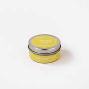 Champagne Toast soy wax candle in yellow tin jar on white background