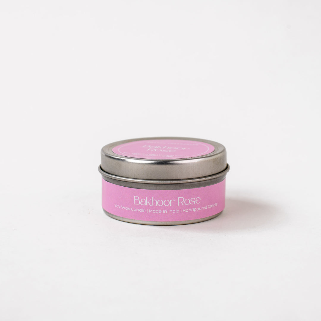 Bakhoor Rose soy wax candle tin with pink label on white background