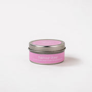 Bakhoor Rose soy wax candle tin with pink label on white background