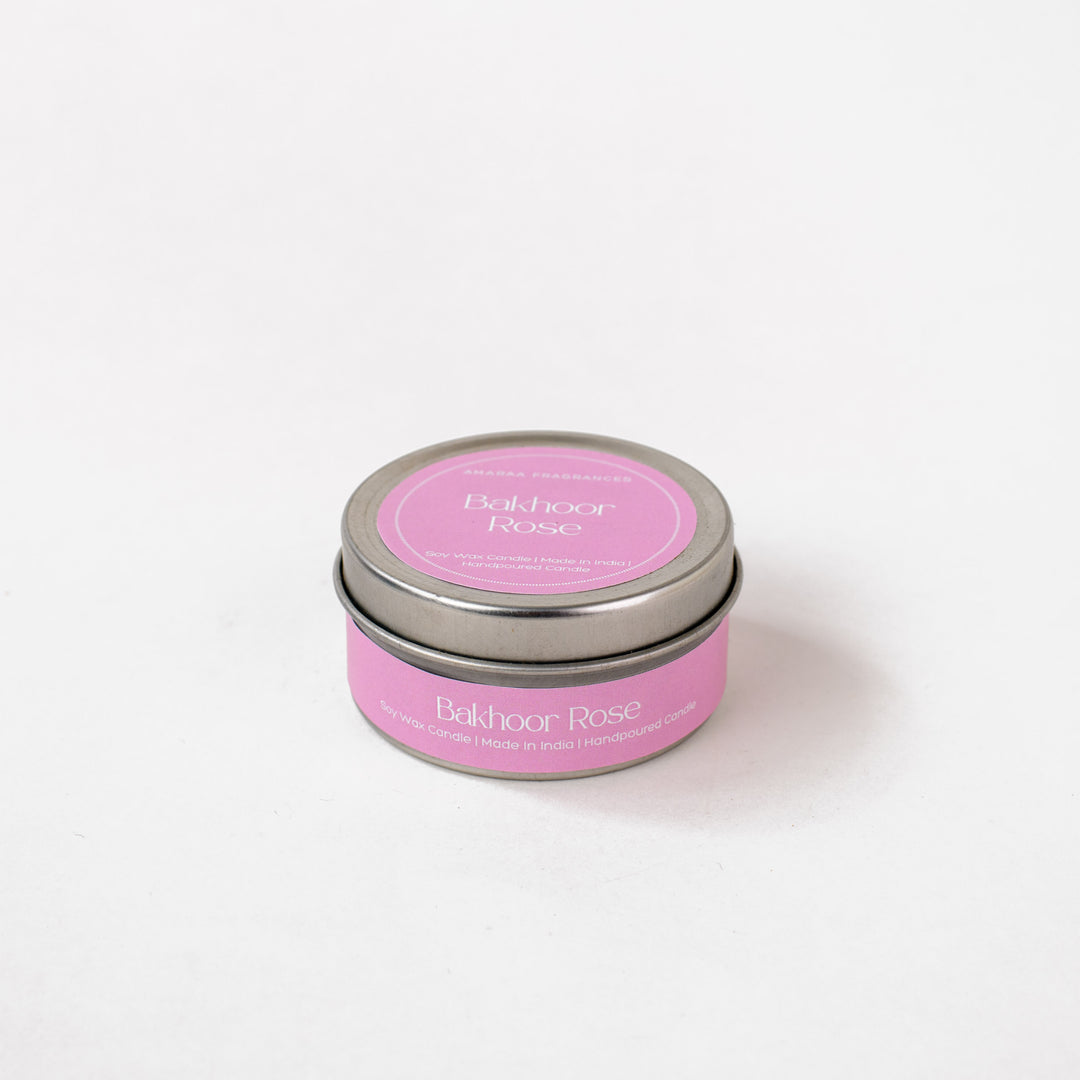 Bakhoor Rose soy wax candle in a pink tin, handpoured, on a white background