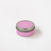 Bakhoor Rose soy wax candle in a pink tin, handpoured, on a white background
