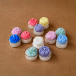 Load image into Gallery viewer, Colorful flower-shaped tealight candles arranged on a brown surface