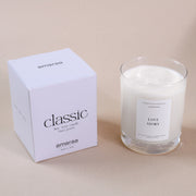 Amaraa classic soy wax candle in glass with white box, labeled Love Story, on beige surface