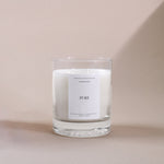 Load image into Gallery viewer, White soy wax candle in a clear glass jar with Pure label on a beige background