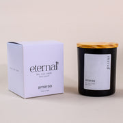 Eternal soy wax candle in black jar with wood lid and branded box by Amaraa Fragrances