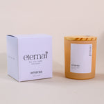 Load image into Gallery viewer, Eternal soy wax candle by Amaraa with box and wooden lid on beige background