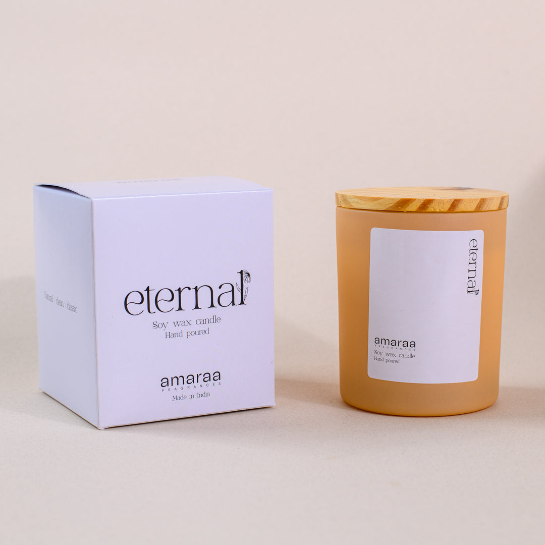 Eternal soy wax candle by Amaraa with box and wooden lid on beige background