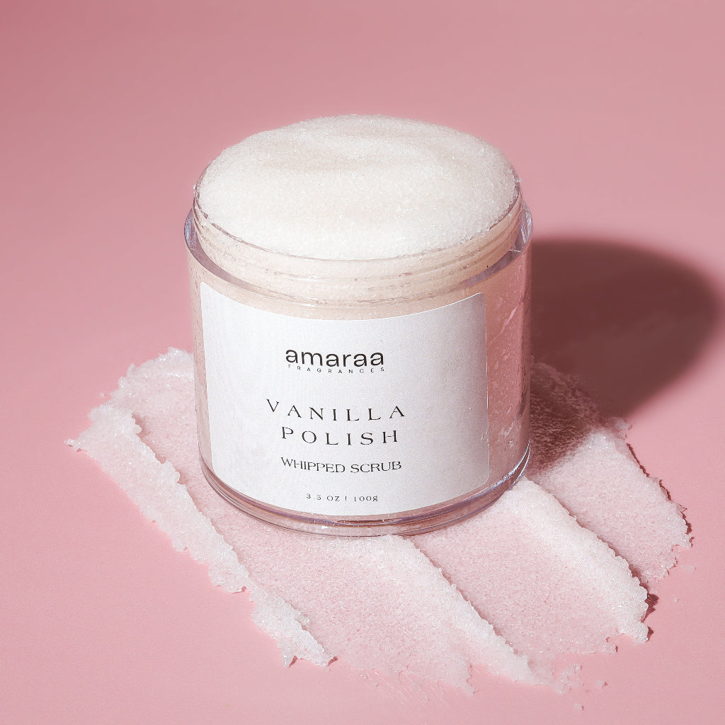 Amaraa Vanilla Polish whipped scrub jar on pink background with scrub spread underneath