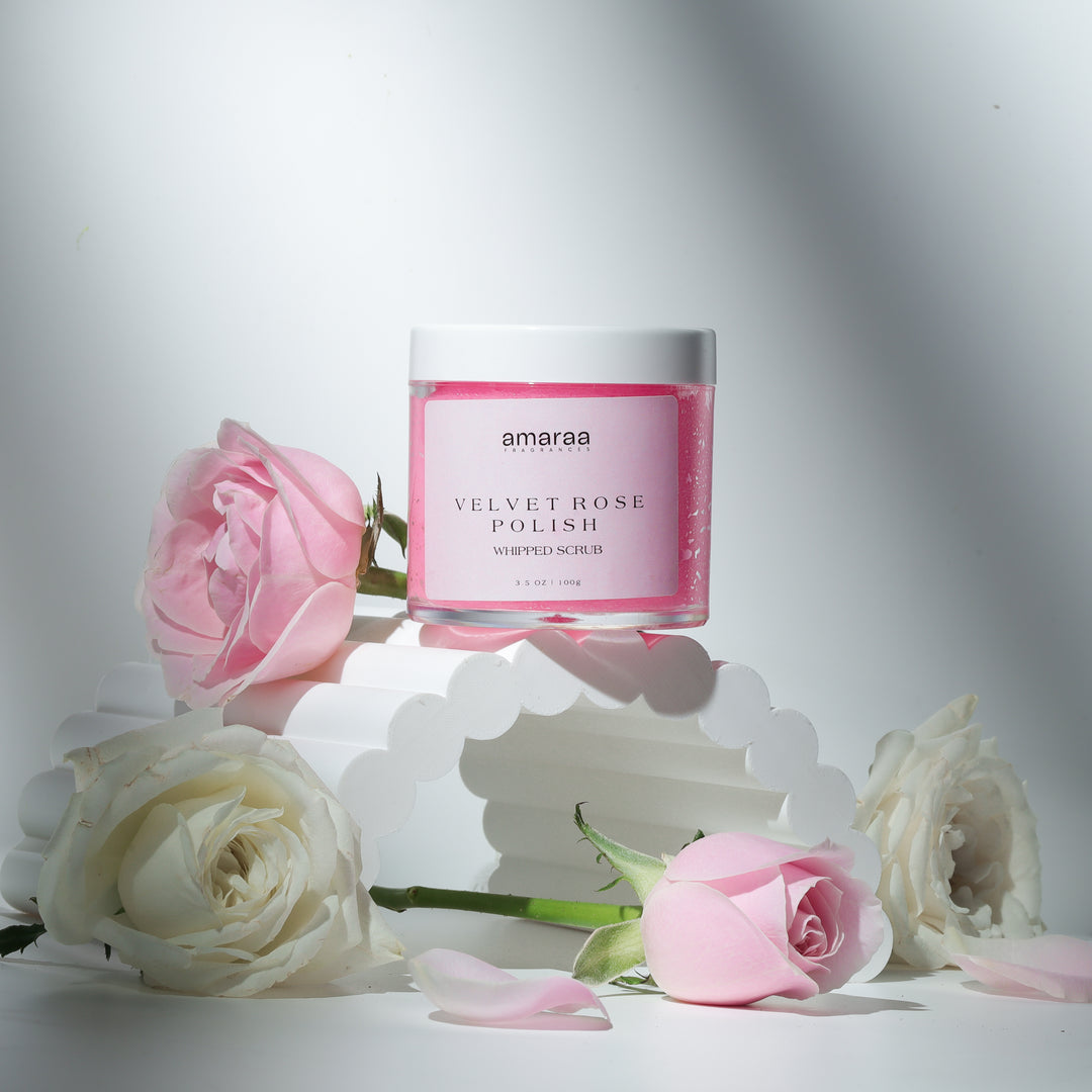 Amaraa Velvet Rose Polish whipped scrub jar with pink and white roses on a white arch display