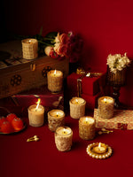 Load image into Gallery viewer, Decorative candles, flowers, gifts, and sweets on a red background for festive decor