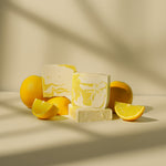 Load image into Gallery viewer, Lemon soap bars with fresh lemons and lemon slices on a neutral background