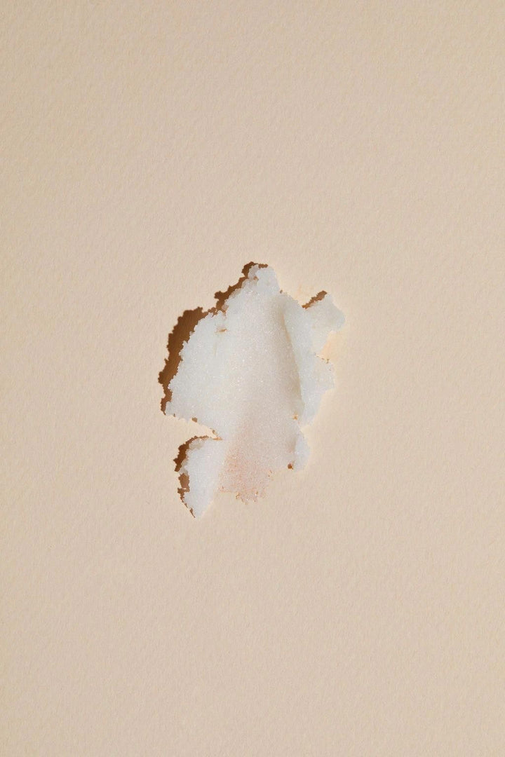 Close-up of a damaged drywall with a hole on a beige painted wall surface