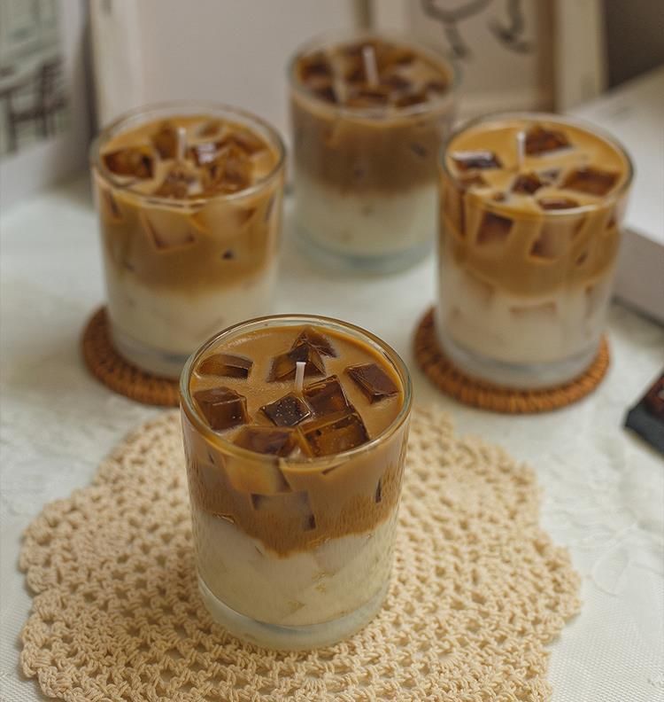 Four iced coffee layered candles with coffee jelly cubes on lace and wicker coasters